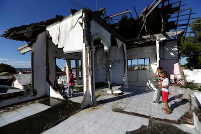 Kids play in a tsunami damaged house in Lampaseh, Banda Aceh, Indonesia. EPA
