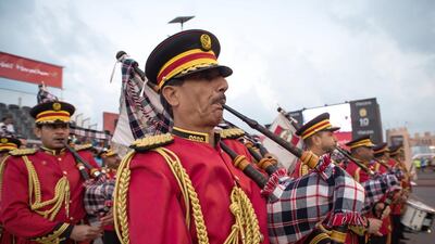Members of the Police Marching Band play the UAE National Anthem before the start of the race.