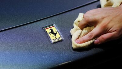 An employee polishes the front of a Ferrari car. Enthusiasts expect Ferrari to showcase its 488 Spider at the Frankfurt International Motor Show. Kai Pfaffenbach / Reuters