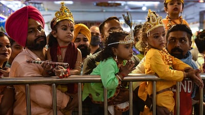Devotees carry their children dressed as Krishna at Shivala Bhaiyaan temple in Amritsar. AFP