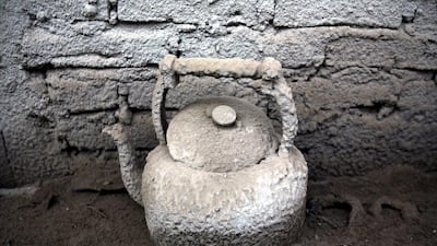 A tea pot covered by ash from Mount Sinabung is seen in a kitchen of a house in Sibintun, North Sumatra, Indonesia, Wednesday, Feb. 5, 2014. The rumbling volcano in western Indonesia unleashed fresh clouds of searing gas, killing more than a dozen of people. Mount Sinabung erupted again Saturday just a day after authorities allowed thousands of villagers who had been evacuated to return to its slopes, saying volcanice activity was decreasing. Binsar Bakkar / AP Photo
