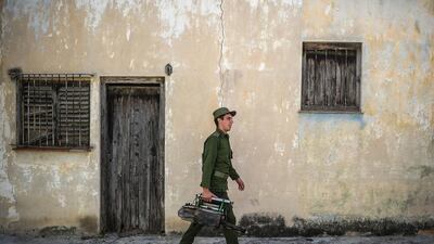 A member of the Cuban army gets ready to fumigate against the Aedes aegypti mosquito to prevent the spread of zika, chikungunya and dengue in a street in Havana. Yamil Lage / AFP Photo