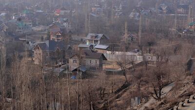 This combination photograph shows a view of snow-covered Tangmarg village on Jan. 27, 2017, top, and the same view on Saturday, Jan. 13, 2024 of Tangmarg, northwest of Srinagar, Indian controlled Kashmir. A prolonged dry spell is sweeping across the Indian-controlled portion of Kashmir during the harshest phase of winter, leaving many people sick and farmers worried about impending water shortages. (AP Photo / Dar Yasin)