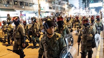 Riot police charge on a street during a demonstration in Yuen Long district in Hong Kong. Getty Images