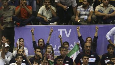 Women cheer while watching a volleyball match between Iran's national team and the United States during the Men's Volleyball World League, at the Azadi (Freedom) stadium in Tehran on June 19, 2015. No Iranian women were allowed to attend the match in keeping with a ban in place since 1979. However, foreign women in Iran are allowed to attend matches of their national teams. Vahid Salemi/AP Photo