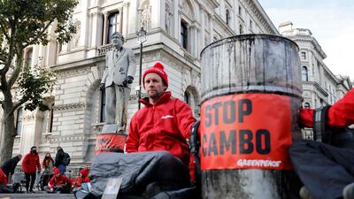 Greenpeace activists stage a sit-in at Downing Street in London, protesting against the Cambo oil field project in the Shetland Islands. AFP
