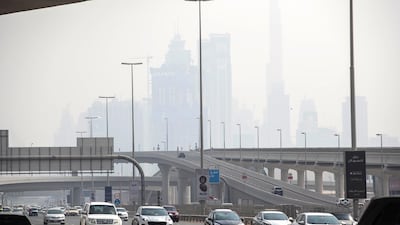 Dubai's Burj Khalifa looms in the background as hot and hazy weather hits the city. Antonie Robertson / The National