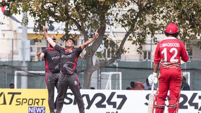 UAE players celebrating taking an Oman wicket during the Cricket World Cup League 2 match at the ICC Academy in Dubai.