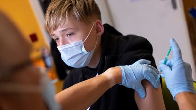 A doctor vaccinates a 13-year-old boy in Berlin. Reuters