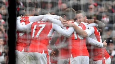 Arsenal players huddle after the own goal against Tottenham on Sunday. Ben Stansall / AFP / November 6, 2016