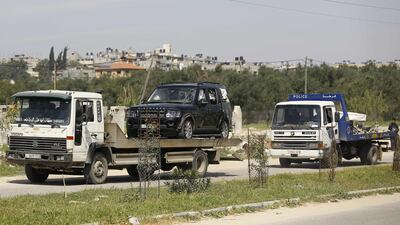 One of the cars of the Palestinian Prime Minister's convoy that was hit by an explosion being towed away to the Gaza strip Erez crossing, in Beit Hanun, the northern access point into the coastal Palestinian territory. Mohammed Abed / AFP