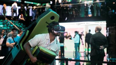 Visitors at Etisalat's booth experiencing a VR world. Reem Mohammed / The National