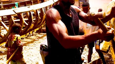 Children help to gather boat building materials, to be put together by their fathers and uncles. Andy Scott / The National