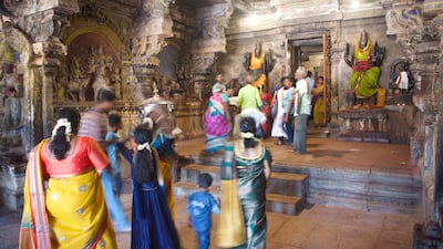 Devotees visit an area dedicated to other deities within the complex