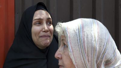 Mary Rezaian, mother of detained Washington Post correspondent Jason Rezaian, speaks with the media as Jason's wife Yeganeh, a correspondent for The National, weeps, after a hearing at the a court in Tehran on Monday, July 13. (AP Photo/Vahid Salemi)