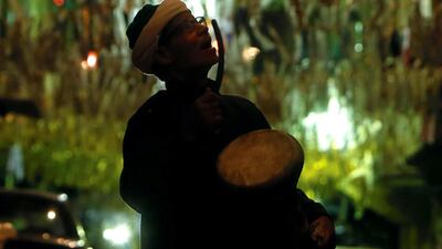 Al-Masharty Moustafa, 60, beats a drum as he wakes residents to eat their pre-dawn Suhoor meals before beginning their fasting for the day during the Muslim Holy month of Ramadan, in Cairo, as Egypt ramps up efforts to slow the spread of the coronavirus disease (COVID-19). REUTERS