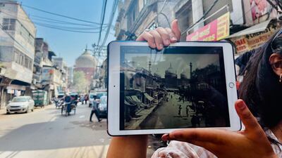 The road leading to Jama Masjid in old Delhi, with guide Anoushka Jain showing an old picture of the same road in the 19th century. Sonia Sarkar for The National