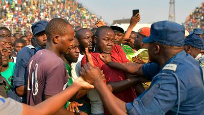 Members of the public scuffle with police and military personnel during a surge to view the body of Zimbabwe's late former president, Robert Mugabe lying in state at the historic Rufaro stadium. Mugabe's family and the government appeared to be deadlocked, over his final resting place after relatives snubbed a plan for him to be buried at a national monument. Mugabe died in Singapore last week aged 95, leaving Zimbabweans divided over the legacy of a leader once lauded as a colonial-era liberation hero, but whose autocratic 37-year rule ended in a coup in 2017. AFP