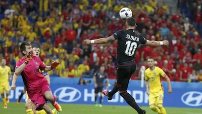 Albania's Armando Sadiku heads in a cross to take the lead on 43 minutes. Kai Pfaffenbach / Reuters