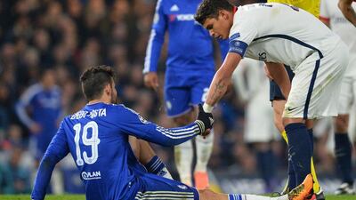 Chelsea striker Diego Costa, left, sits injured on the pitch talking with Paris Saint-Germain defender Thiago Silva. Glyn Kirk / AFP