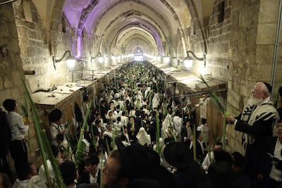 Orthodox Jews pray during the Jewish holiday of Sukkot near the gate to the Al Aqsa Mosque complex in Jerusalem's Old City. EPA