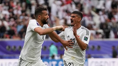 Iraq's Saad Natiq, left, celebrates after scoring his side's first goal with Merchas Doski. AP