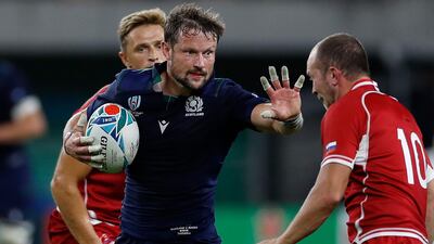 Scotland's centre Peter Horne (C) fends off a tackle by Russia's fly-half Ramil Gaisin (R) during the Japan 2019 Rugby World Cup Pool A match between Scotland and Russia at the Shizuoka Stadium Ecopa in Shizuoka. AFP