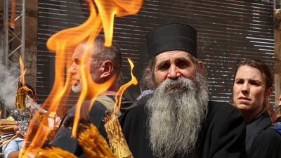 An Orthodox priest in the courtyard of Jerusalem's Holy Sepulchre church during the Holy Fire ceremony. AFP
