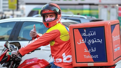 A Talabat driver is all thumbs up at central Abu Dhabi. Victor Besa/The National