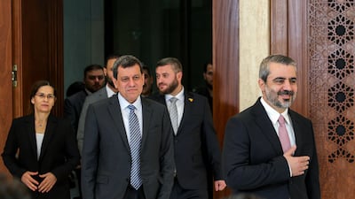 Mazloum Abdi, centre, head of the Kurdish-led Syrian Democratic Forces, with Syrian Foreign Minister Asaad Al Shibani, right, in Damascus. AFP