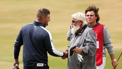 Bryson DeChambeau, right, shakes hands with John Daly of the US on the eighteenth green. Daly finished the day with a one over par round of 71. Getty