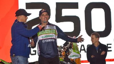 Casale Racing's Chilean rider Ignacio Casale (C) speaks during the podium ceremony in Jeddah ahead of the 2020 Dakar Rally. AFP