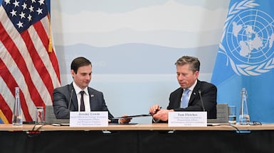 Senior US official for foreign assistance, humanitarian affairs and religious freedom Jeremy Lewin, left, exchanges documents with UN aid chief Tom Fletcher during the signing ceremony at the US Mission in Geneva, on December 29, 2025. AFP