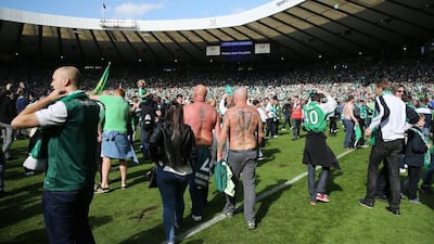 Hibernian fans celebrate on the pitch at the end of the match after winning the Scottish Cup Final. Reuters / Russell Cheyne