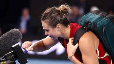 Aryna Sabalenka writes a message on a TV camera after the match. AFP