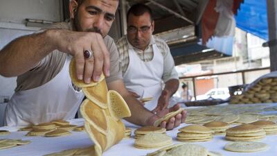 Essam (left) and Achmed Nimer at the Abu Ramadan for Sweets bakery in Gaza City on July 14. Despite the conflict they open their shop to sell their traditional Ramadan qatayef. Heidi Levine for The National