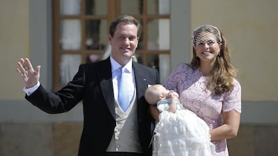 Christopher O'Neill, left, waves to the crowds as Princess Leonore is held by her mother, Princess Madeleine, right, outside the church after the christening ceremony in the Drottningholm Palace church outside Stockholm, Sweden, Sunday, June 8, 2014. AP