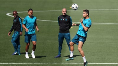 Real Madrid forward Cristiano Ronaldo heads the ball in training as Zinedine Zidane looks on. Sergio Perez / Reuters