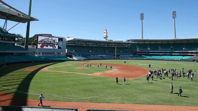 Ground staff prepare the baseball field at Sydney Cricket Ground where Major League Baseball will inaugurate its 2014 season with a two-game series between the Los Angeles Dodgers and Arizona Diamondbacks beginning Saturday March 22, 2014. Rick Rycroft / AP