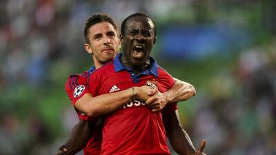 CSKA Moscow's Seydou Doumbia celebrates with teammate Zoran Tosic after scoring the 1-1 equaliser on Tuesday night in the Champions League play-off first leg match. Miguel A Lopes / EPA