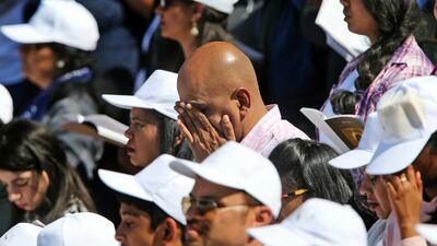 Worshippers pray during the first ever papal Mass in the Gulf at the Zayed Sports City in Abu Dhabi. AP
