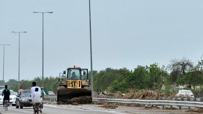 Workers in Al Musanna repair damage caused by Cyclone Shaheen. Photo: Reuters