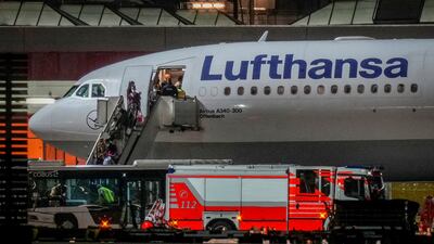 People disembark from a Lufthansa aircraft arriving from Tashkent, Uzbekistan, that landed in Frankfurt, Germany. On board were about 130 people that were evacuated from Afghanistan.