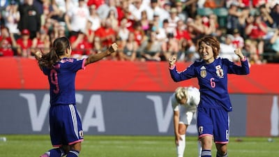 Nahomi Kawasumi, left, and Mizuho Sakaguchi of Japan celebrate after England's own goal put the Japanese ahead in added time of the Women's World Cup semi-final on Wednesday. Todd Korol / Getty Images / AFP / July 1, 2015