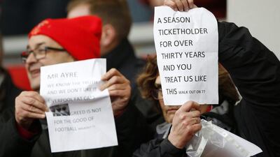 Liverpool fans hold up signs in protest against season ticket prices before the game. Action Images via Reuters / Carl Recine
