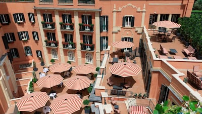 Terracotta colours and retro-striped parasols abound at Hotel De La Ville.