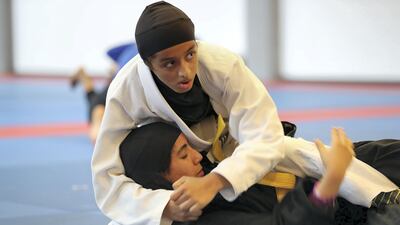 Shamma Al Klbani, in black, and Meena Al Mazroori train at Zayed Sports City in Abu Dhabi. Pawan Singh / The National