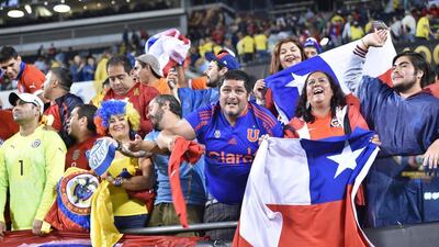 Fans of Chile cheer for their team at the end of the Copa America Centenario semifinal football match against Colombia, in Chicago, Illinois, United States, on June 22, 2016. / AFP / Nicholas Kamm