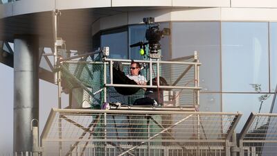 A camera operator lies in a hammock while waiting for the second practice session of the Formula 1 Etihad Airways Abu Dhabi Grand Prix at Yas Marina Circuit in Abu Dhabi on November 2, 2012. Christopher Pike / The National