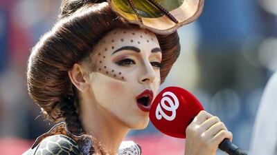 Eirini Tornesaki, a vocalist in KURIOS by Cirque du Soleil, sings the national anthem before a baseball game between the Washington Nationals and the Cleveland Indians. Alex Brandon / AP Photo